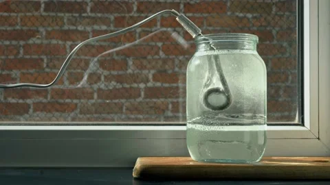 The process of boiling water in a glass jar by heating the boiler from Stock Footage 148880381
