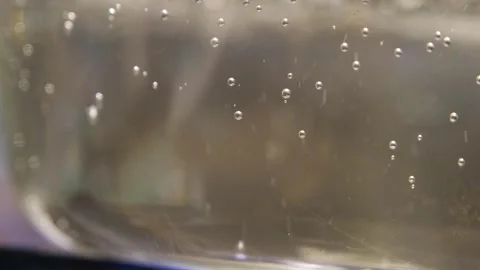 The process of boiling water slow motion. Water is boiling in a pan close-up. Bo Stock Footage 283630340