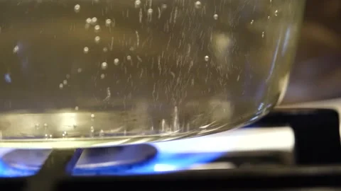 The process of boiling water slow motion. Water is boiling in a pan close-up Stock Footage 307314196