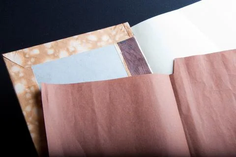 The process of book binding; adding the brown endsheets Stock Photos
