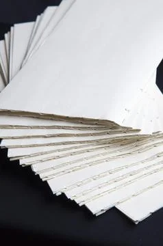 The process of book binding; pile of raw paper folders Stock Photos