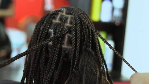The process of braiding African braids on the mixed boy Video stock 164131797
