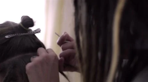 The process of braiding dreadlocks to young white guy Stock Footage 60363441