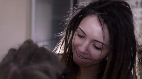 The process of braiding dreadlocks to young white guy Stock Footage 60363448