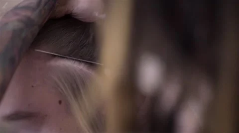 The process of braiding dreadlocks to young white guy Stock-Footage 60363475