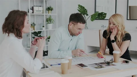 The process of brainstorming in interior design studio. Workers are intently Stock Footage 106191796