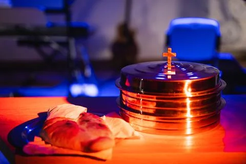 The process of breaking bread in the modern church. Stock Photos
