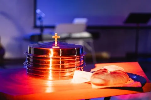 The process of breaking bread in the modern church. Stock Photos