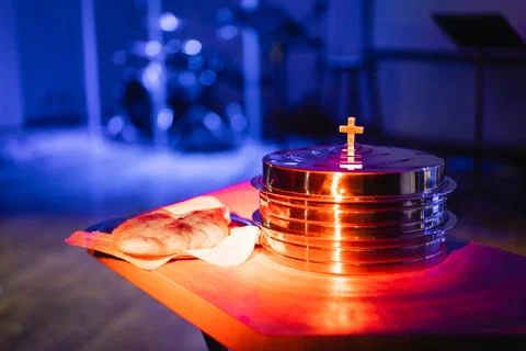 The process of breaking bread in the modern church. Stock Photos
