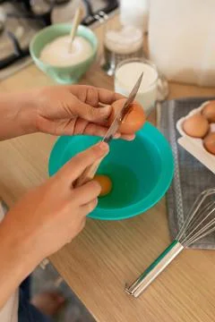 The process of breaking hen's eggs into a bowl, cracked shells Stock Photos