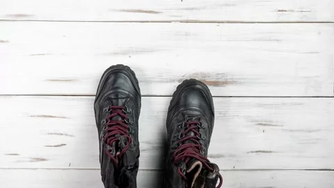 The process of breaking shoes. A pair of boots wear out and fall apart. Aging Stock Footage 169531683