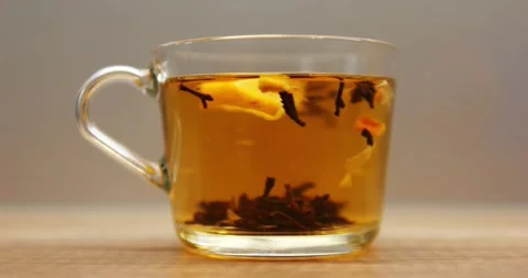 Process of brewing black tea with fresh lemon slice in transparent mug Stock Footage 310255233
