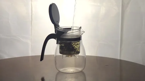 Process of Brewing black tea in glass tea pot Stock Footage 162846879