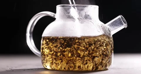 Process of brewing black tea in glass transparent teapot at dark background Stock-Footage 172107666