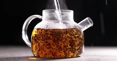Process of brewing black tea in glass transparent teapot at dark background Video stock 172108022