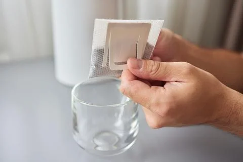 The process of brewing coffee. Water is poured into a drip coffee bag in a mug Stock Photos