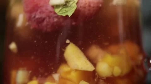 The process of brewing fruit tea in a glass teapot close-up Stock Footage 154911222
