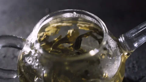 The process of brewing herbal tea in a glass transparent teapot, home tea Stock Footage 96289335