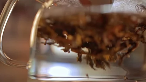 The process of brewing medicinal herbs. In a glass bowl, water is stirred and Stock Footage 264405622