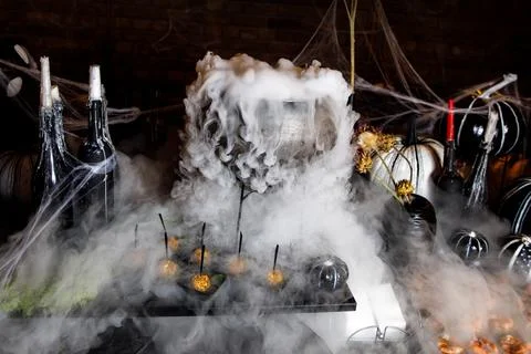 The process of brewing a potion in a cauldron. Stock Photos