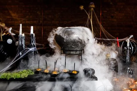 The process of brewing a potion in a cauldron. Stock Photos