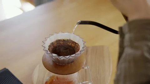 Process of brewing pour over coffee with V60, hot water drip into container Stock Footage 254731420