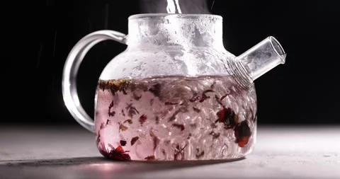 Process of brewing red tea in glass transparent teapot at dark background Stock Footage 172208522