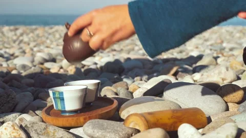 The process of brewing tea. Chinese ceremony on a pebble beach. Stock Footage 168527271