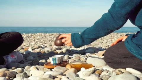 The process of brewing tea. Chinese ceremony on a pebble beach. 動画素材 168527619