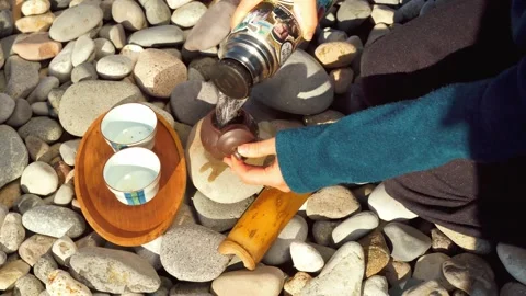 The process of brewing tea. Chinese ceremony on a pebble beach. Stock Footage 168527808