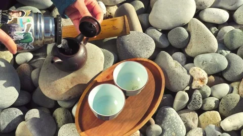 The process of brewing tea. Chinese ceremony on a pebble beach. Stock Footage 168527812