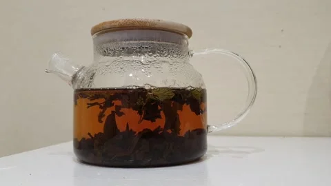 The process of brewing tea in a transparent glass teapot, timelapse Stock Footage 235565292