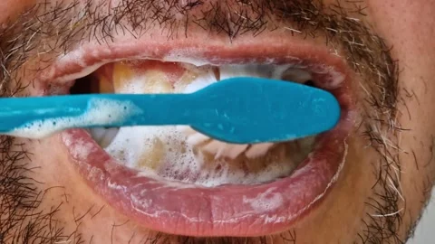 The process of brushing teeth with a brush close-up Stock Footage 346694260