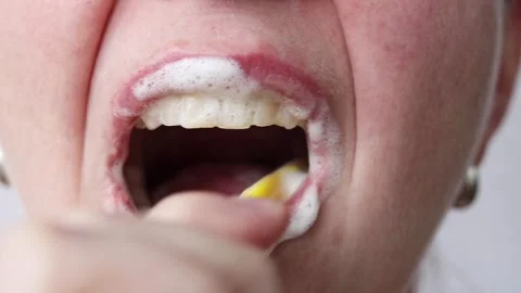 The process of brushing teeth with a toothbrush and toothpaste close-up Stock Footage 346238429