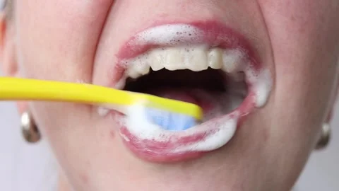 The process of brushing teeth with a toothbrush and toothpaste close-up Stock Footage 346238515