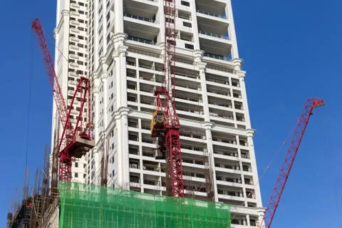 Process of building, cranes at work on construction site Stock Photos