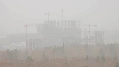 The process of building a high-rise multi-story building in a snowstorm Stock Footage 287602040