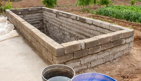 The process of building a home pool for storing water Stock Photos