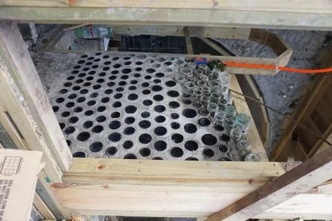 Process of building an interior wall of bottles and cement Stock Photos