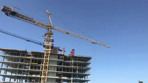 The process of building multi-storey building. Tower crane at construction site Stock Footage 199094392