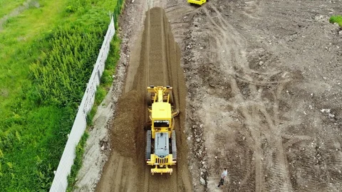 The process of building roads. The tractor aligns the ground. Stock Footage 111527702