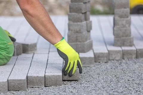 Process of building sidewalk, worker laying interlocking walking path Stock Photos