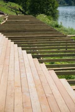 The process of building a wooden deck by the river. the river, the work of a Stock Photos