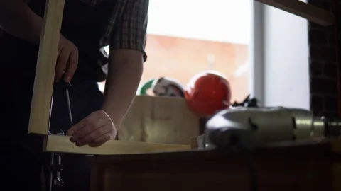 The process of building a wooden table, the carpenter collects the base. Stock Footage 90741803
