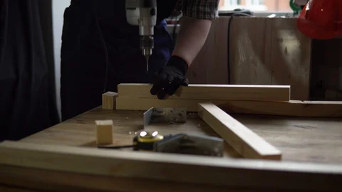 The process of building a wooden table, the carpenter collects the base. Stock Footage 90742321