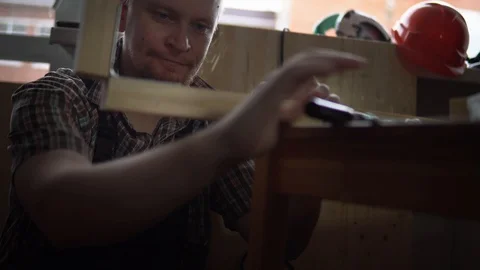 The process of building a wooden table, the carpenter collects the base. Stock Footage 90800709