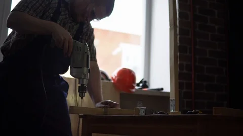 The process of building a wooden table, the carpenter collects the base. Stock Footage 90800863