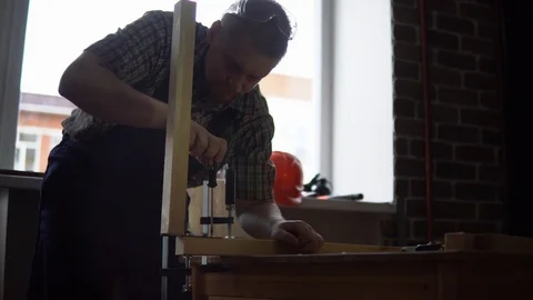 The process of building a wooden table, the carpenter collects the base. Stock Footage 90800910