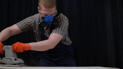 The process of building a wooden table, the carpenter polishes the countertop. Stock Footage 91177384