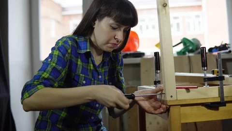 The process of building a wooden table, the carpenter collects the base. Stock Footage 91569864